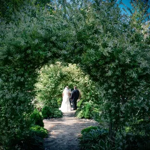 a bride and groom walking down the aisle