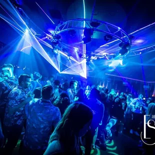 a crowd of people dancing at a nightclub