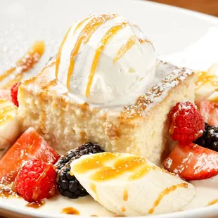 a piece of cake with ice cream and fruit