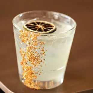 a glass of lemonade with a slice of lemon
