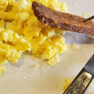 The breakfast platter, that cheap scrambled egg stuff, and dry, hard sausage patty you&apos;d get at a school cafeteria.