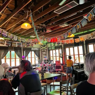 people sitting at tables in a restaurant