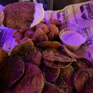 a pile of potato chips and dip
