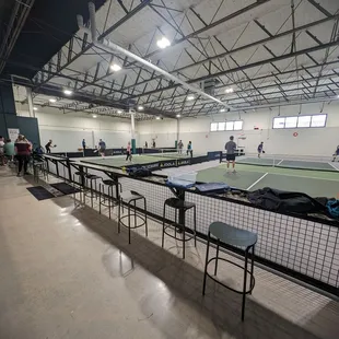 a group of people playing tennis