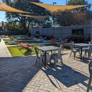 a patio with tables and chairs