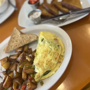 Spinach omelette with french toast and home fries.