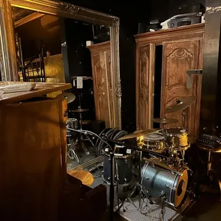 a drum kit and a wine glass