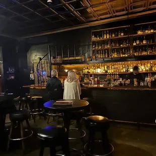a woman standing at a bar