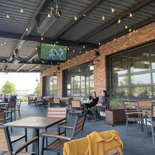 a patio area with tables and chairs