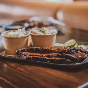 a plate of ribs and coleslaw