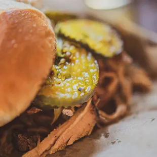 a pulled pork sandwich with pickles