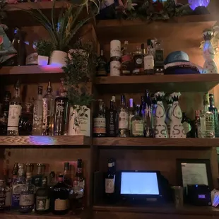 a shelf full of liquor bottles