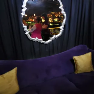 a purple couch and a mirror