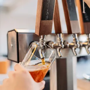 a person pouring a beer