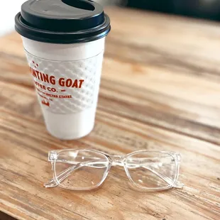 a cup of coffee and a pair of glasses