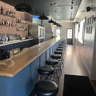 a long bar with stools