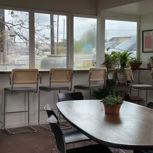 a table and chairs in front of a window