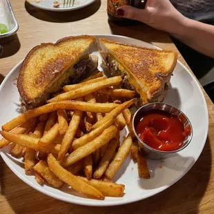 Braised brisket melt - braised brisket, cheddar, pepper jack, caramelized onions, horseradish aioli, grilled artisan Swiss.