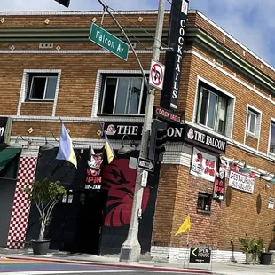 the corner of the street in front of a brick building