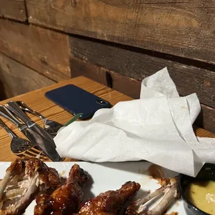 a plate of chicken wings and dipping sauce