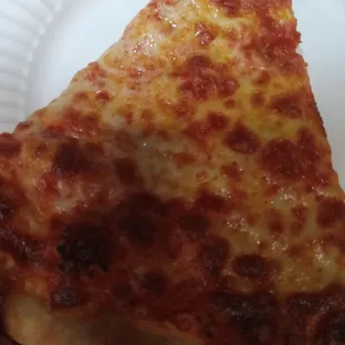 a slice of pizza on a paper plate