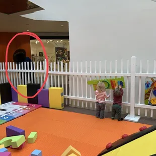 Random bystander talking to these kiddos. Very easy for someone to swipe them up and run because of the fencing being too low.