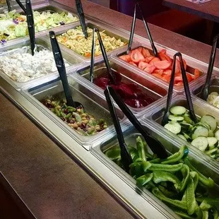 a salad bar with a variety of salads