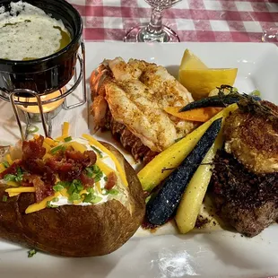 Surf and Turf prime filet with crab cake, brown butter, grilled lobster tail and carrot Babettes.