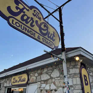 a sign for the far out lounge and stage