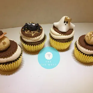 four cupcakes decorated to look like halloween
