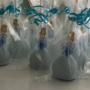 a row of plastic bags with princess figurines on them