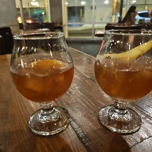 two glasses of drink on a table