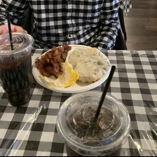 Farmhouse breakfast with biscuits and sausage gravy, bacon and eggs