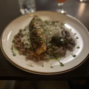 Cajun spiced salmon over rice, stewed collards and hoppin John's