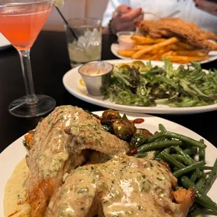 Half baked chicken with mapled Brussels sprouts and green beans, boudin balls, catfish platter