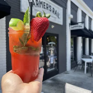 a hand holding a drink