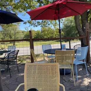 tables and chairs with umbrellas