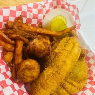 a basket of fried fish and fries