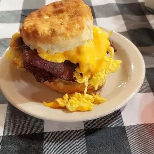 a breakfast biscuit with eggs and bacon