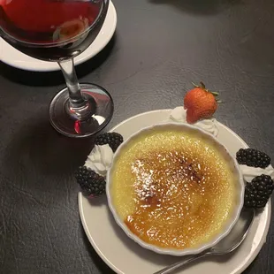 a bowl of creme and a glass of wine