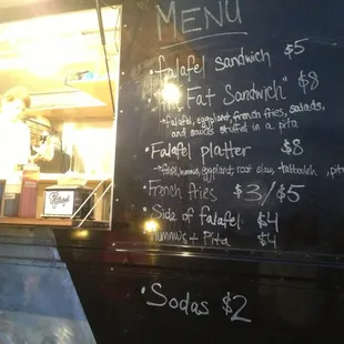 a menu written on the side of a food truck