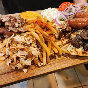 Mixed Grill - Sampling of Pork and Chicken Gyro Meat, Loukaniko, Pork, Chicken and Lamb Souvlaki, Tzatziki, Tirokafteri, Pita &amp; Fries.