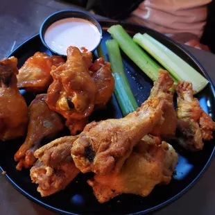 a plate of chicken wings and celery
