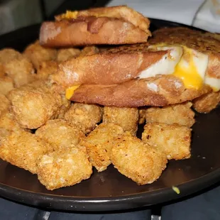 a sandwich and tater tots