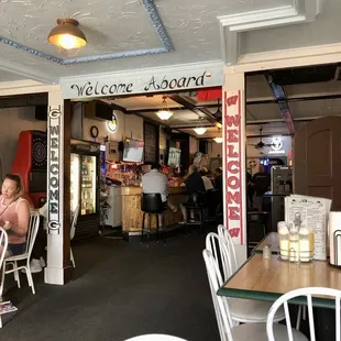 a woman sitting at a table in a restaurant