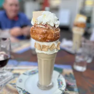 an ice cream cone with whipped cream on top