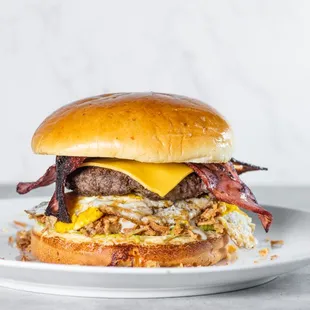 a hamburger with bacon and cheese