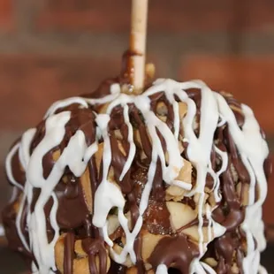 an apple covered in chocolate and nuts