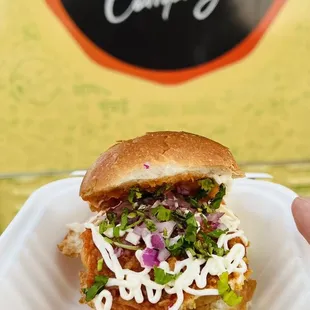 a hand holding a sandwich