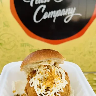 a hand holding a sandwich